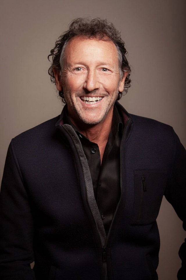 Smiling man with brown backdrop