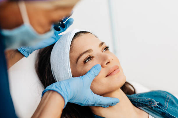 Attractive young woman is getting a rejuvenating facial injections at beauty clinic.