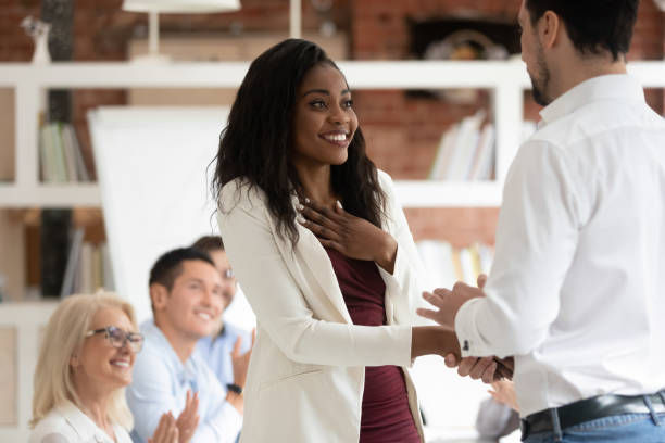 Happy proud black female employee get rewarded
