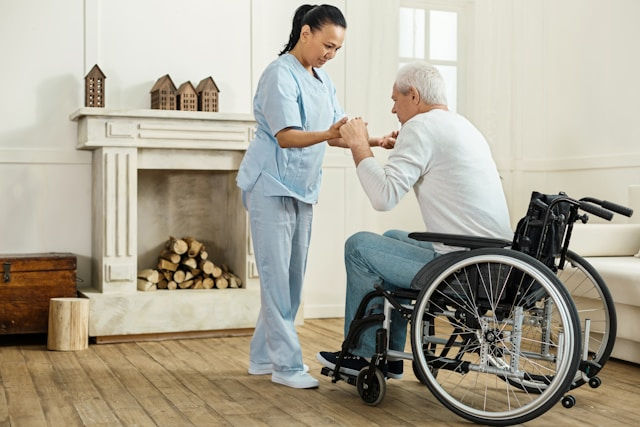 careful professional experienced female caregiver holding her patient