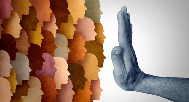 A group of colorful silhouette profiles faces a blue-toned hand extended in a stop gesture, symbolizing resistance. Neutral background.