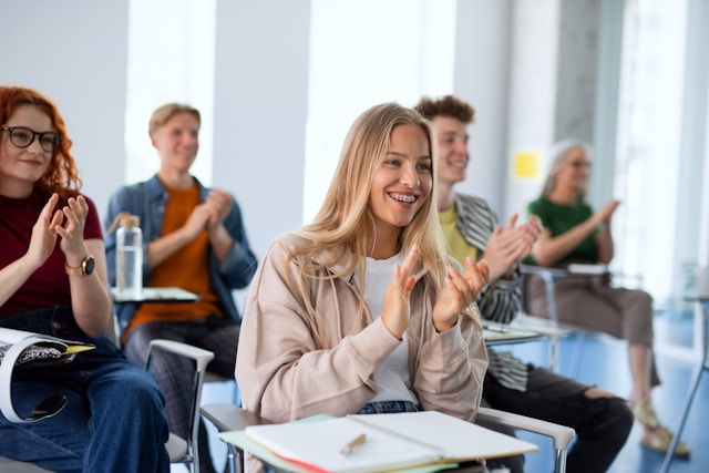 a portrait of group of university students sitting in classroom