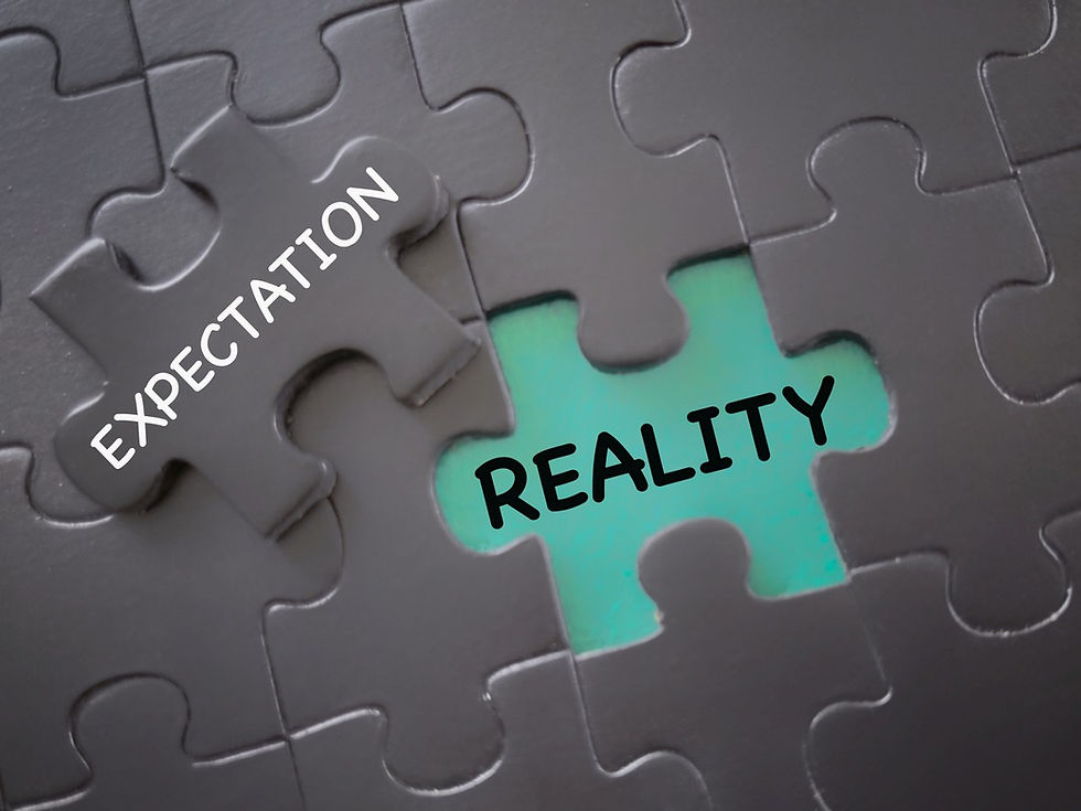 Puzzle pieces on a dark surface, one labeled "EXPECTATION," the other missing labeled "REALITY" on green. Symbolizes contrast.