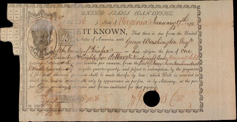 Antique U.S. loan certificate from 1792, beige with decorative border, George Washington's name, and handwritten annotations. A hole is punched on the right.