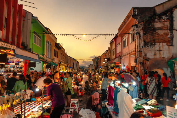 Bustling night market with vibrant stalls and crowds on a colorful street, warm lights creating a lively and festive atmosphere.