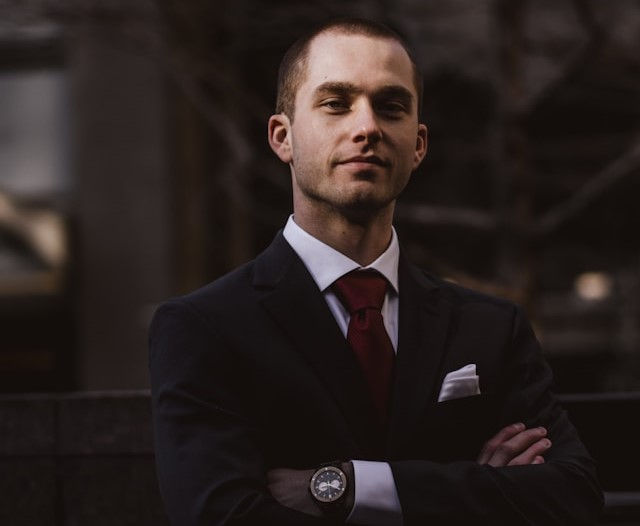 man wearing black notched lapel suit jacket