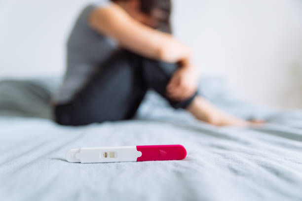 Negative pregnancy test. sad woman on background 