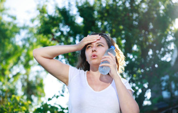 Young woman sweating in a warm summer day 