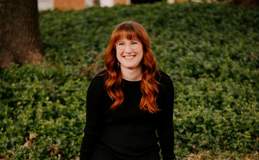 a smiling photo of Katie wearing black sweater.