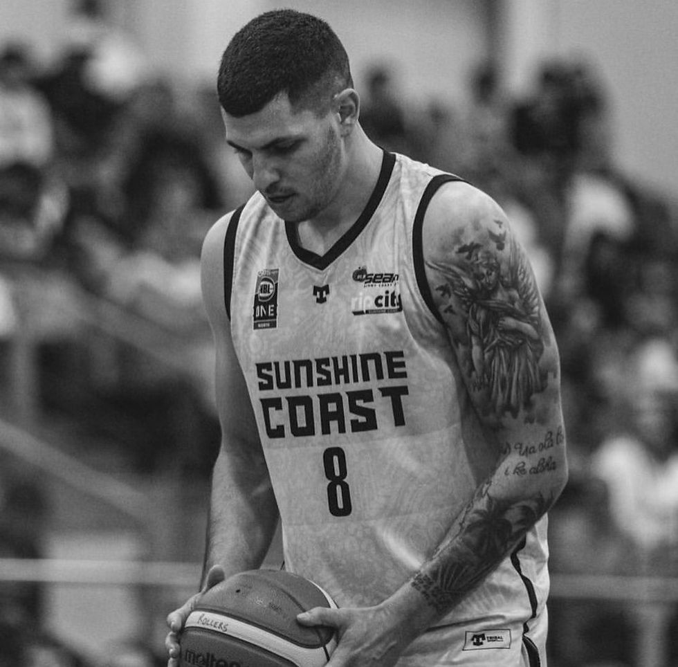  a basketball player wearing a jersey with "Sunshine Coast" written on it, along with the number 8.