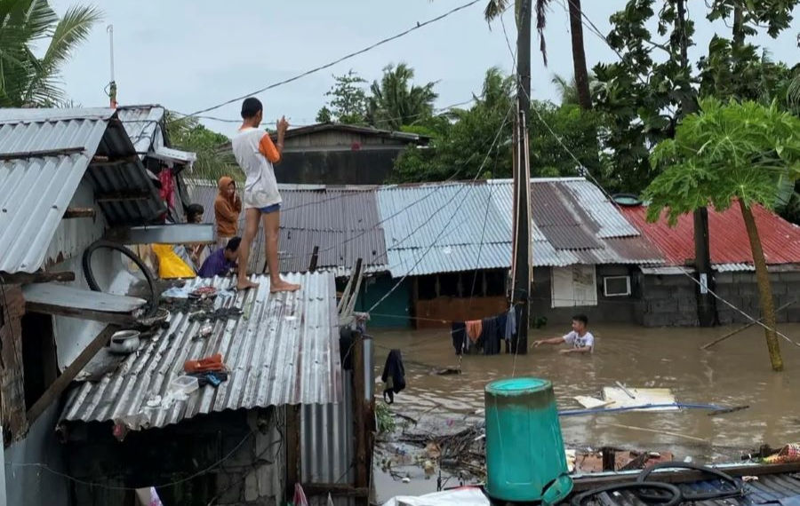 People on their roof during flood, cause by typhoon