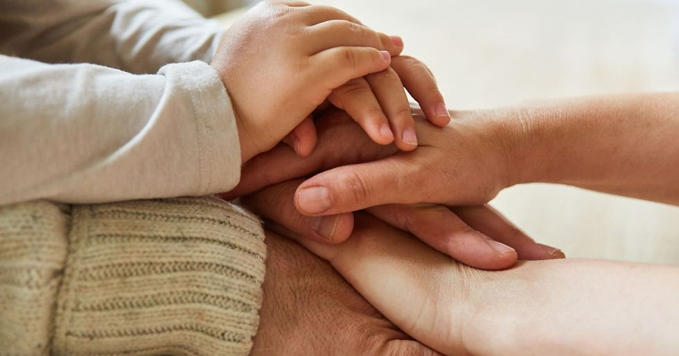 Close-up of multiple hands stacked together, symbolizing unity and support