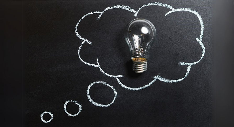  chalk-drawn thought bubble on a blackboard, with a light bulb placed inside the bubble, symbolizing a bright idea or a moment of inspiration.