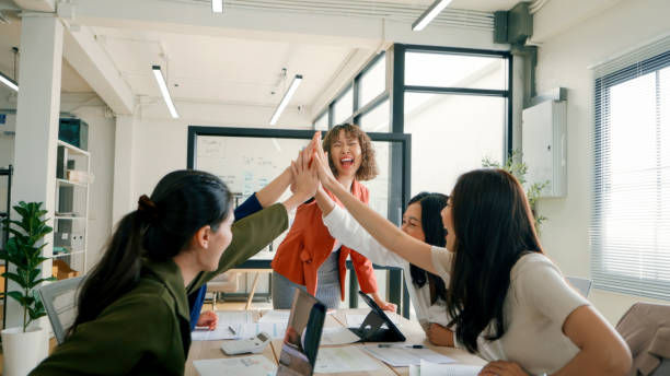 team of business professionals celebrating with a high-five