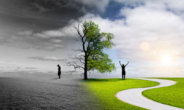 A tree splits a grayscale barren landscape from a vibrant green field. On each side, a person displays contrasting emotions, somber and joyful.