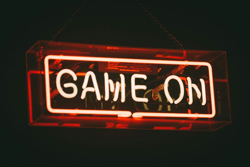 Neon sign reading "GAME ON," glowing in orange-red against a dark background, creating an energetic and lively atmosphere.
