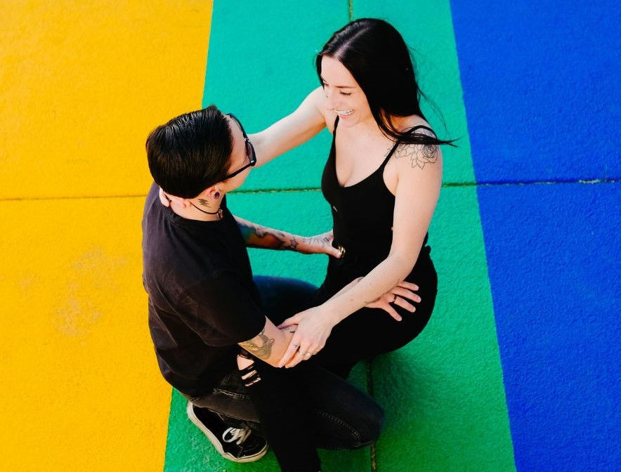 a couple having fun with a colored background