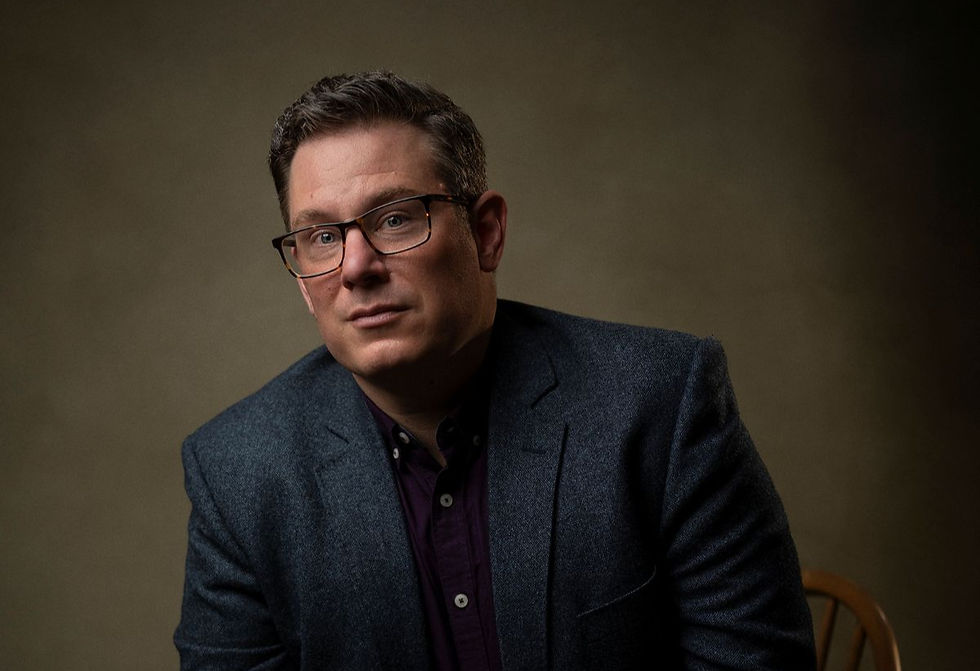 A photo of John Tepe wearing a navy blue suit.
