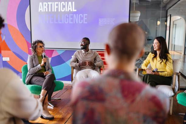 Panel discussion on artificial intelligence with three speakers in a colorful room, audience blurred in foreground.