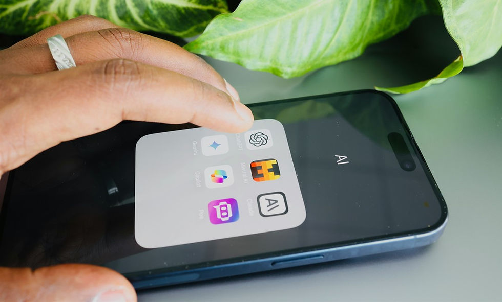 Hand opening an AI folder on a smartphone, showing app icons on a dark screen beside green plant leaves.