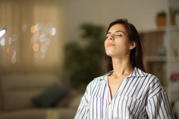 Satisfied woman breathing at home in the night