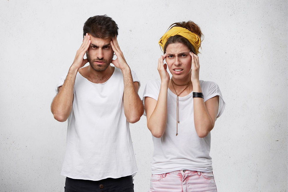 Two people in white shirts touch their temples, looking stressed. The woman wears a yellow headband. White background, serious mood.