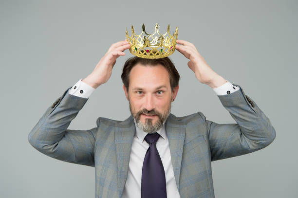 A photo of happy man wearing a crown.
