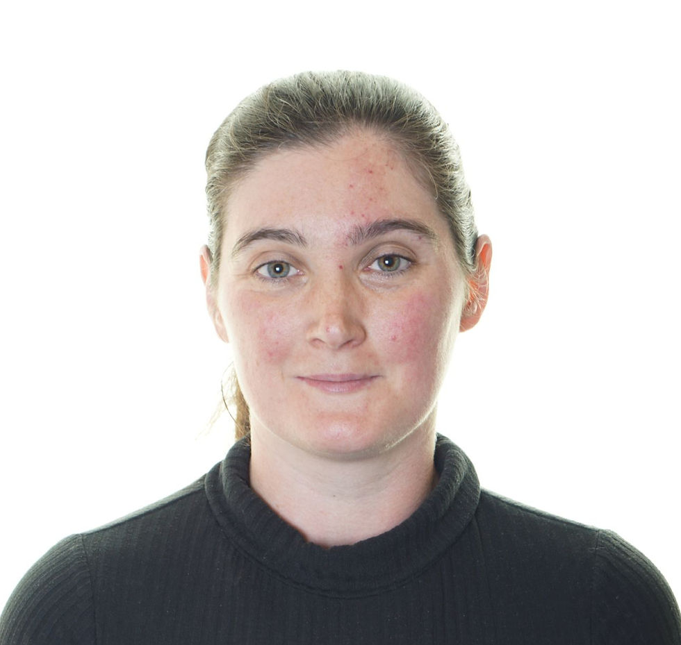 Portrait of a woman with tied-back hair in a black turtleneck, facing forward against a bright white background, neutral expression