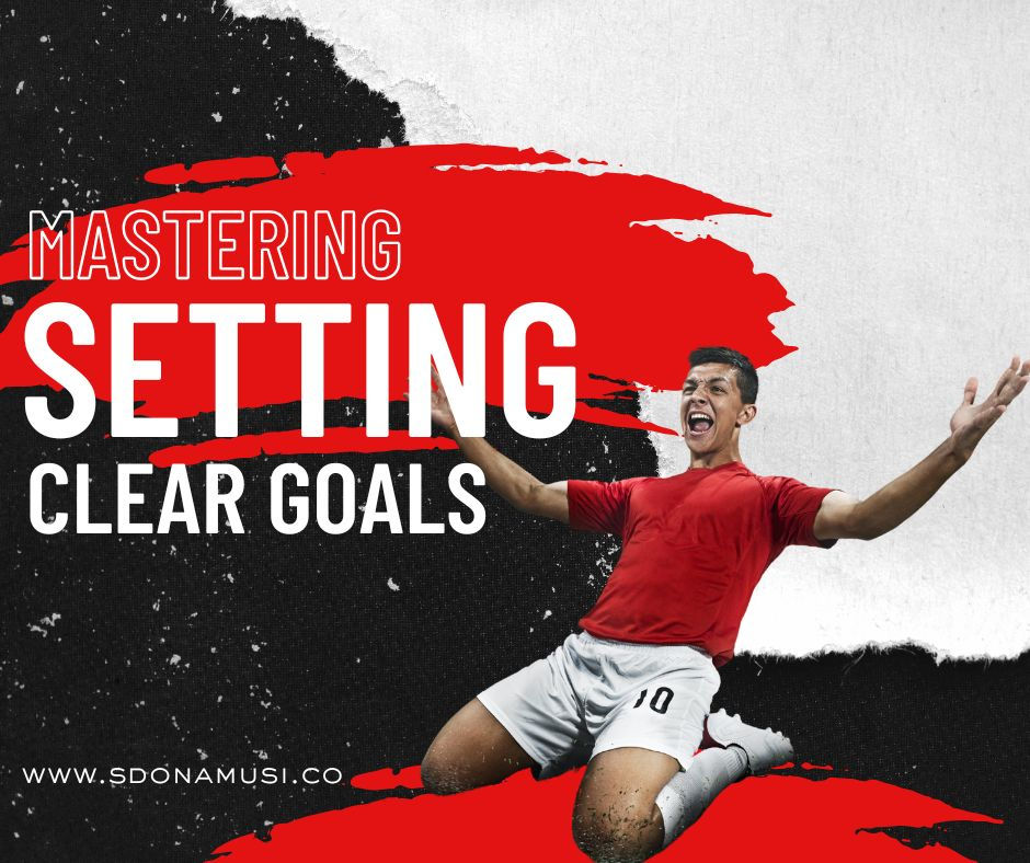 Soccer player celebrating, sliding on knees, wearing red shirt and white shorts. Text: Mastering Setting Clear Goals. Background: red, black, white.