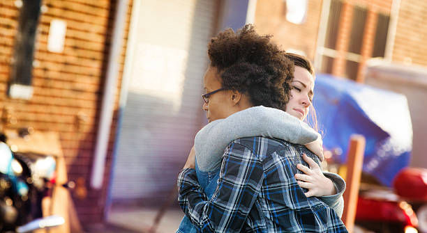Young women forgiving each other with a hug 