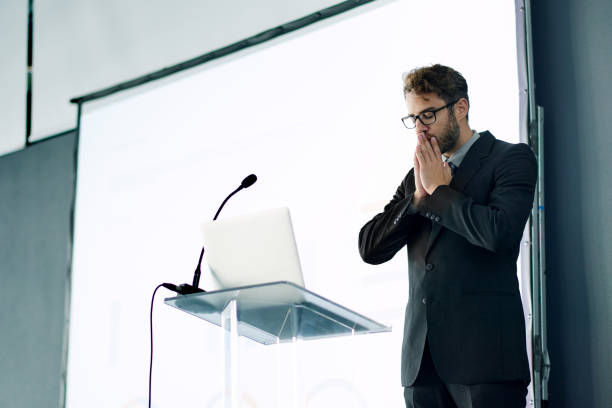 Shot of a young businessman looking nervous while rehearsing a speech