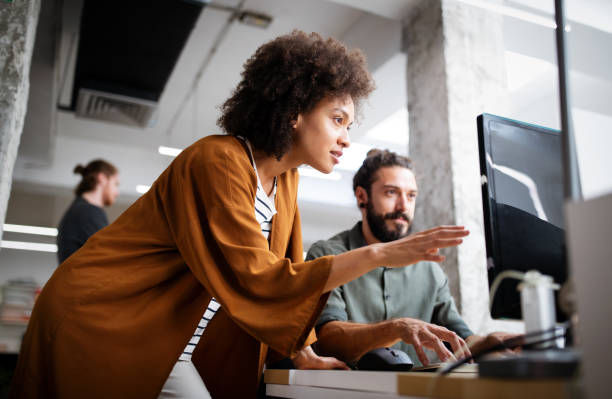Programmers working cooperating at IT company developing apps.