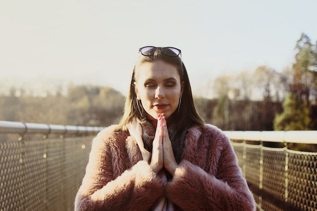 Woman in brown fur coat feeling grateful in the morning