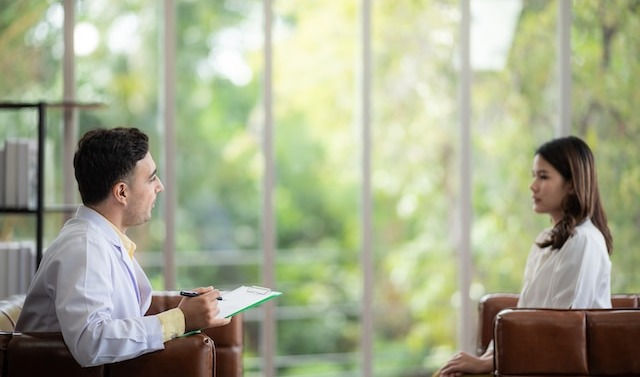 Young sitting with her psychologist