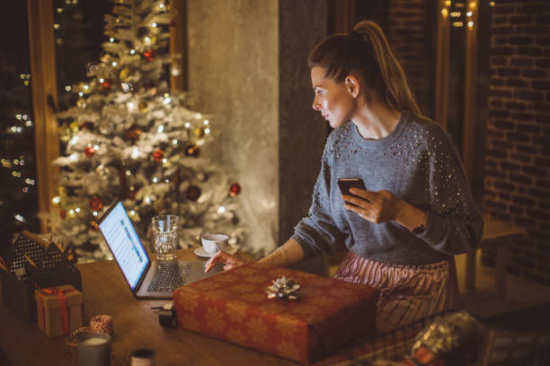 Woman wrapping gifts for Christmas at home.