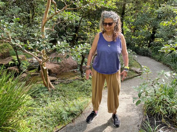 Photo of a senior woman walking on garden