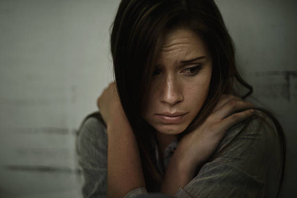 A young woman looking anxious and fearful.