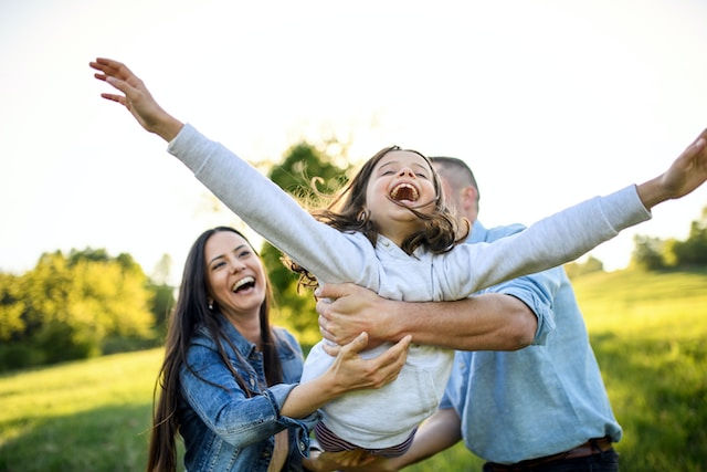 A photo of a happy family in the garden.