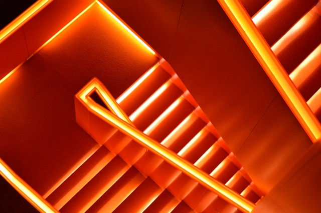 Photo of stairs with red neon lights