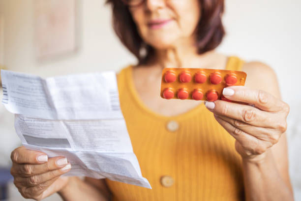 Close up of a woman using medicine pills.