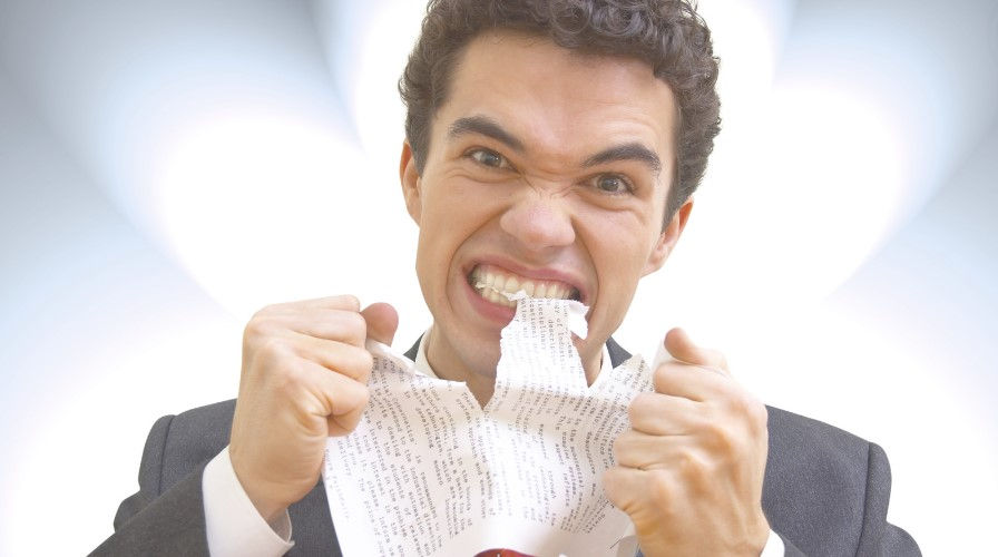 a man tearing a paper