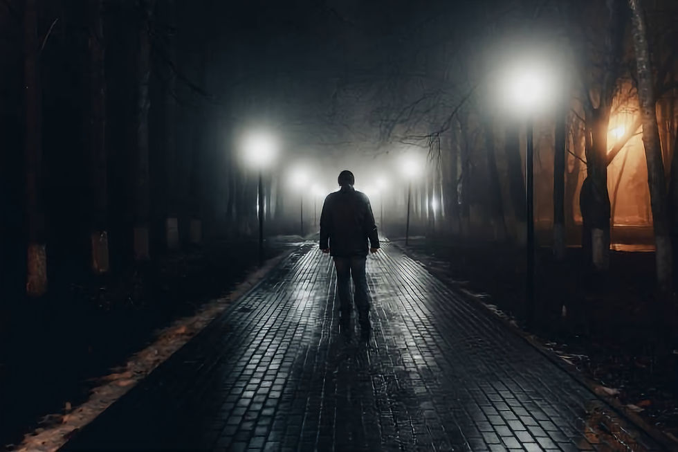 Person walking on street in the dark night
