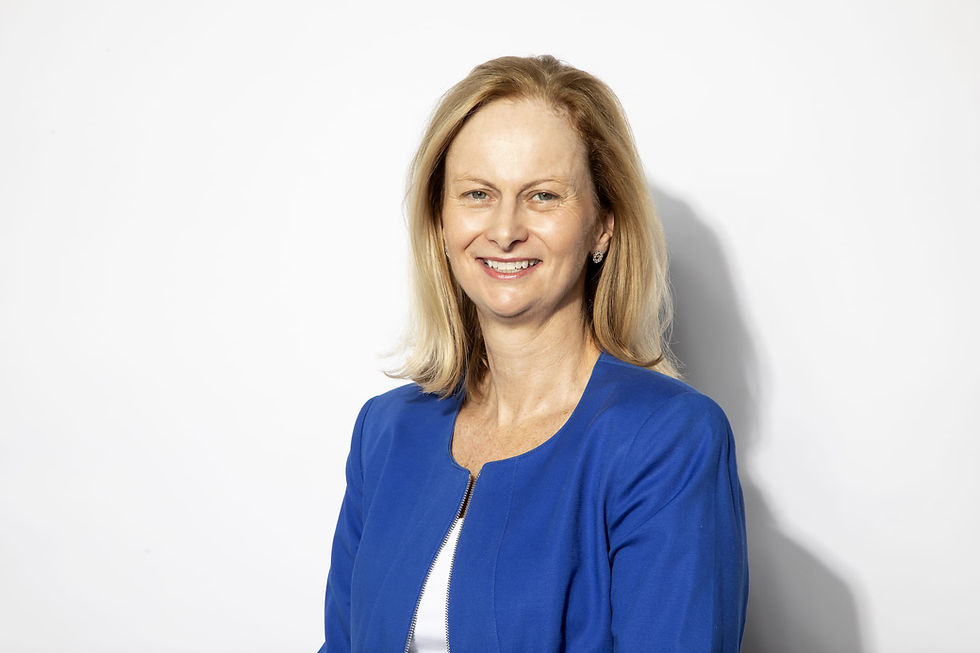 woman in blue coat smiling at camera