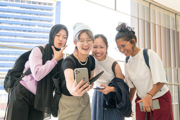 Group of young women laughing while taking selfie