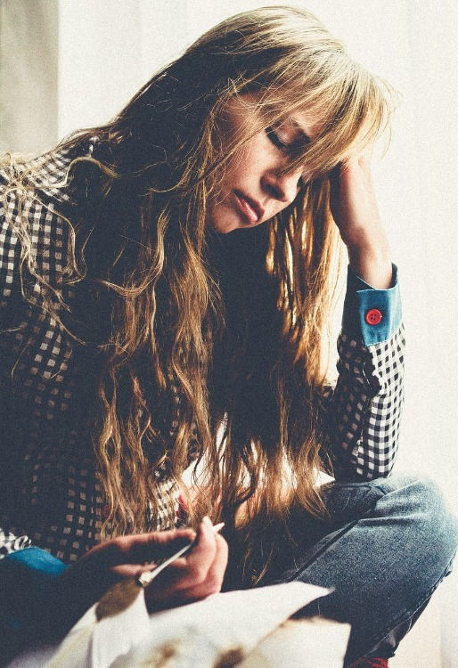 A lady holding a pen.