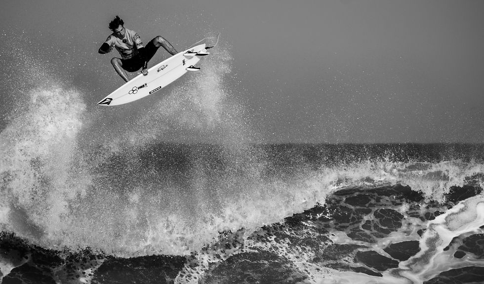 man surfing in grayscale photo
