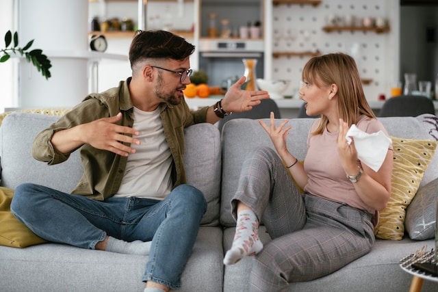 Boyfriend and Girlfriend are arguing on the couch