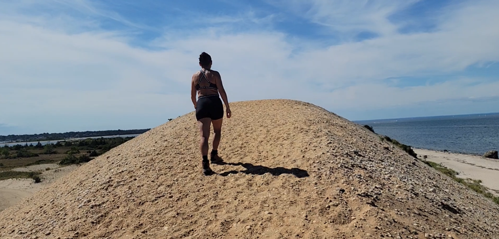 Woman walking on a hill near beach