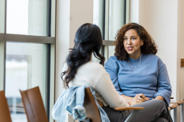 A photo of two woman having a conversation.