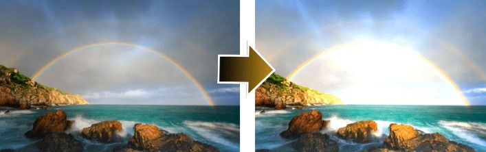 photo of the sea with dark clouds and rainbow